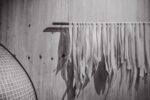 White pasta drying on a rack indoors.