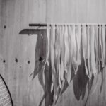 White pasta drying on a rack indoors.