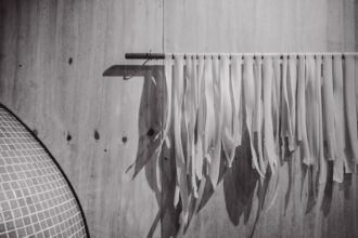 White pasta drying on a rack indoors.
